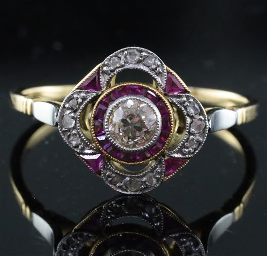A 1920s gold and platinum, ruby and diamond set cluster ring, size U.